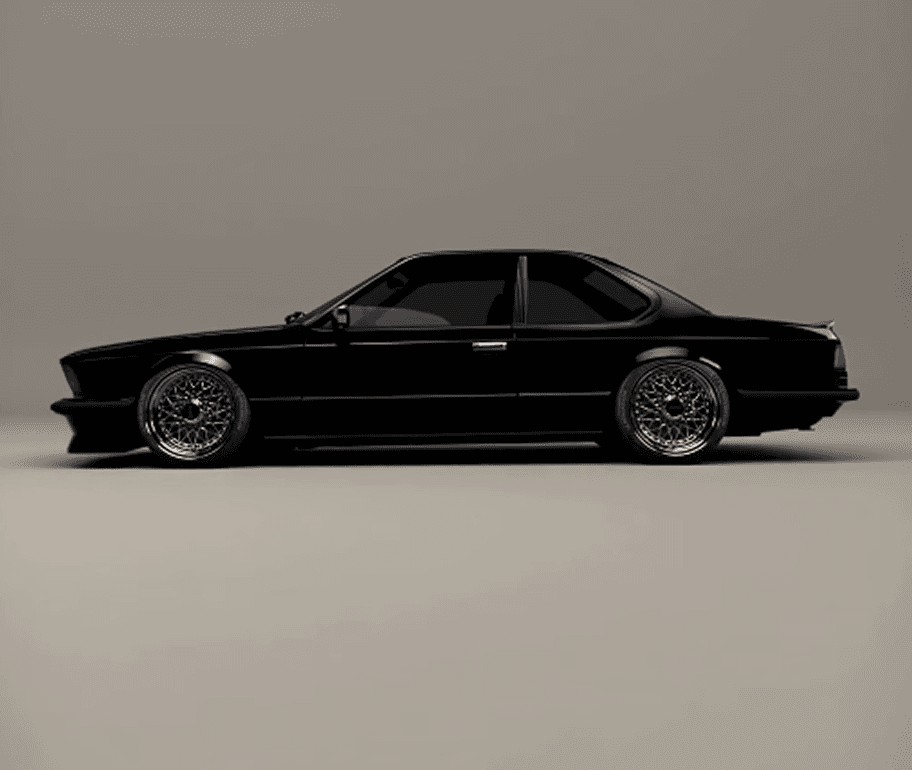 Blacked-out BMW E24 6 Series coupe, lowered on modern mesh wheels, in a grey studio